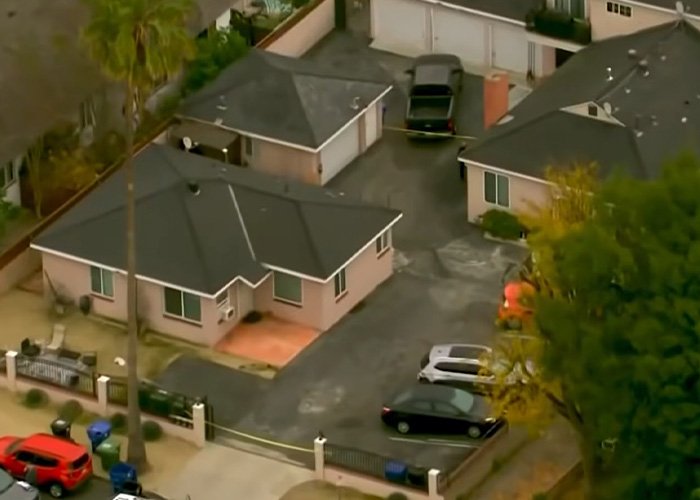 Aerial view of a residential home with police tape after husband uncovers teacher’s affair in explosive diary discovery.