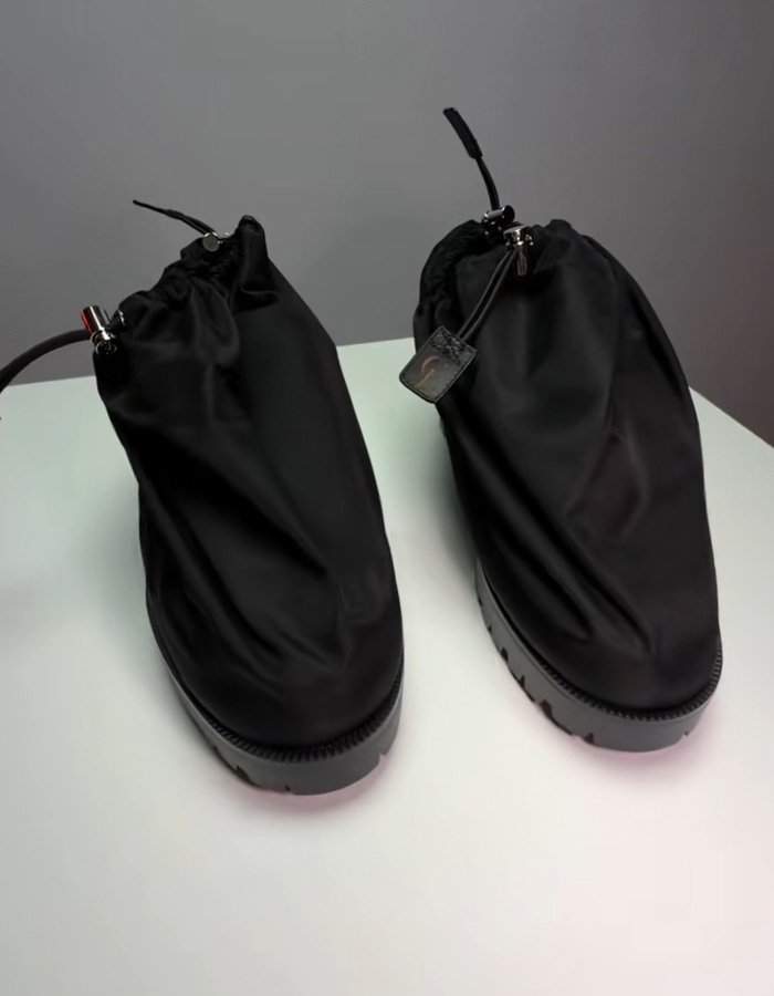 Black Brooklyn Beckham style shoes from Jaden Smith Christian Louboutin debut collection displayed on white surface.