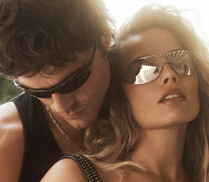 Margot Robbie and Jacob Elordi wearing sunglasses in a steamy shoot highlighting their age gap after cheating accusations
