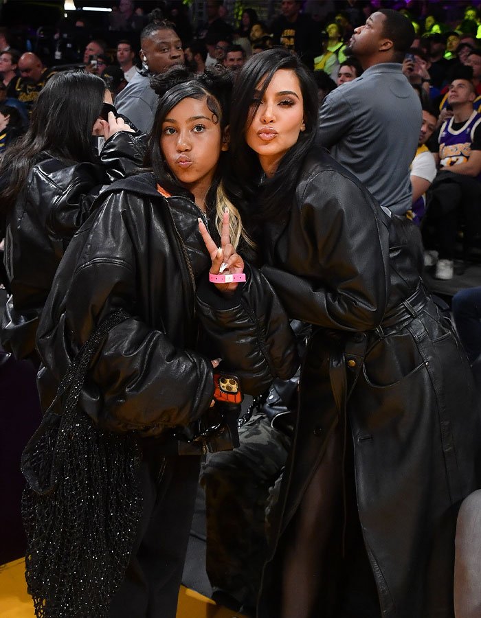 Kim Kardashian and North West posing together at a crowded event, highlighting viral livestream parenting controversy.