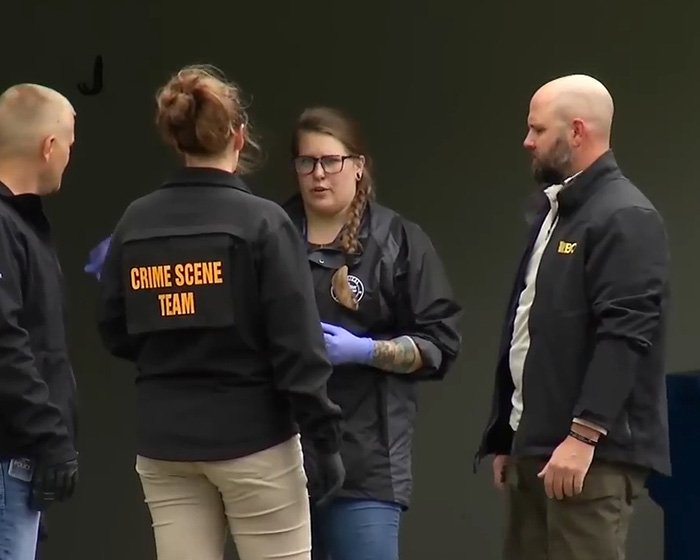 Crime scene team members discussing a homicide investigation involving a pregnant woman at an outdoor location.