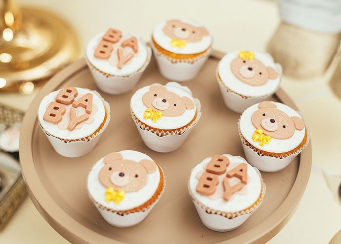 Cupcakes decorated with teddy bears and baby lettering, representing an inappropriate baby shower idea rejected by MIL.