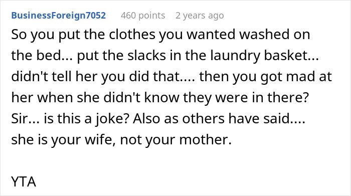 Screenshot of a Reddit comment criticizing a man blaming his wife for not having slacks for his business trip.