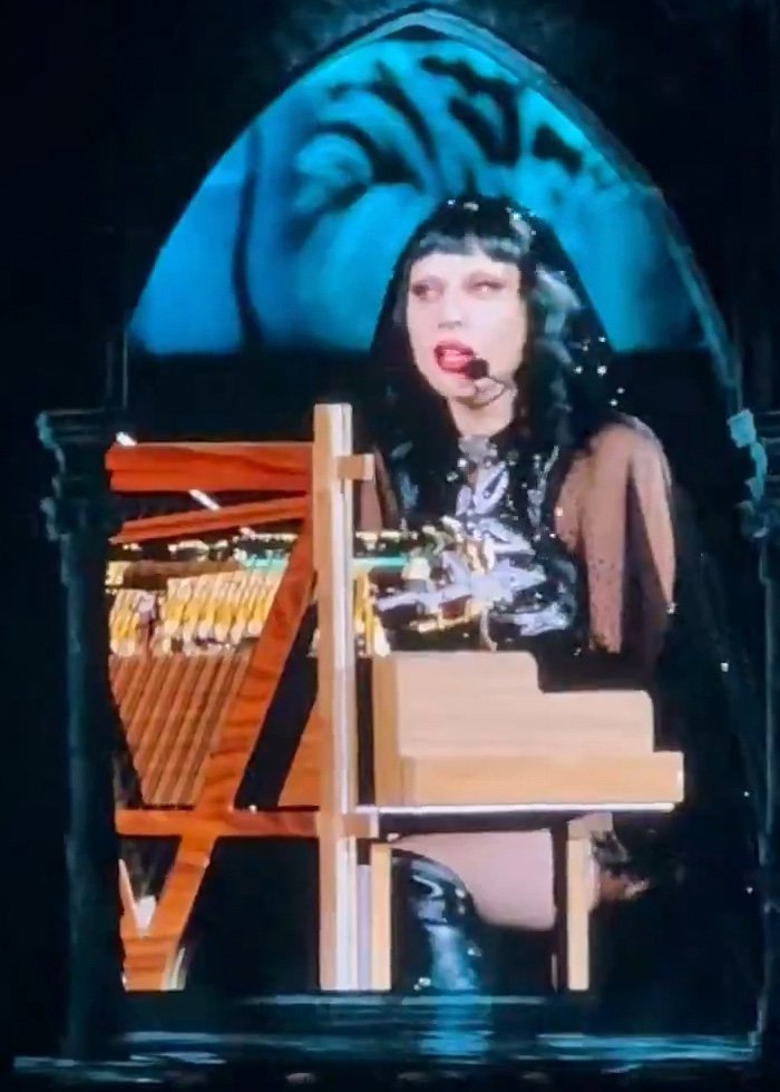 Lady Gaga performing at piano during concert, delivering bold ICE speech that surprised the audience unexpectedly.