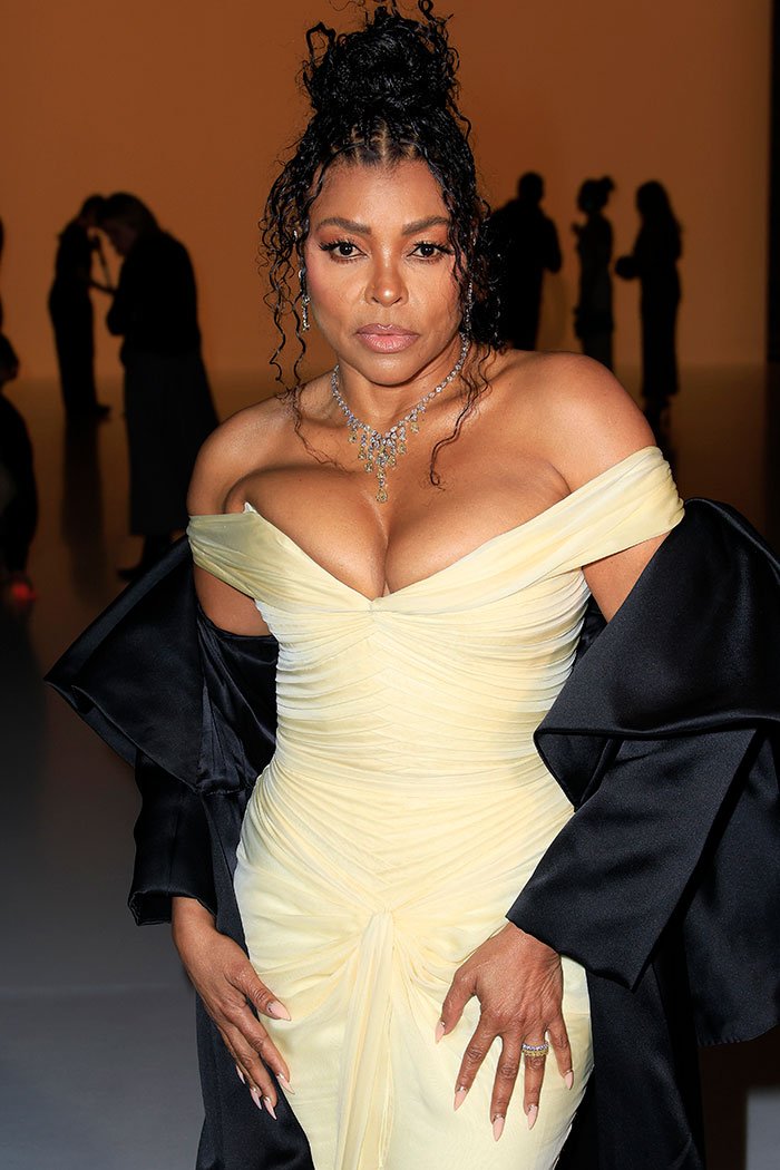 Taraji P. Henson in an off-shoulder yellow dress and black shawl, face drawing attention over possible changes.