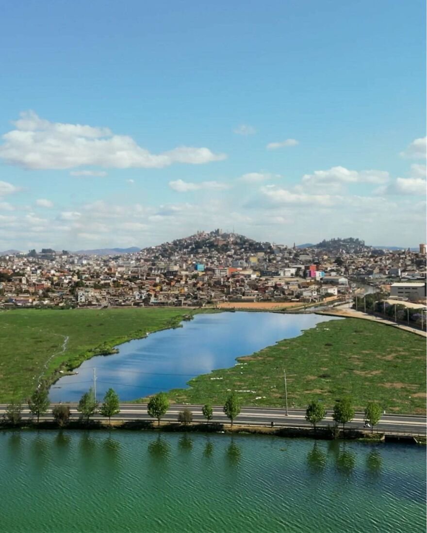 Cityscape with water and greenery under blue sky representing 15 nations setting new global standard for paid leave policies.
