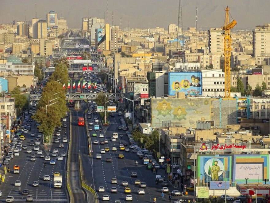 Busy city street with traffic and buildings, representing 15 nations setting new global standard for paid leave policies.