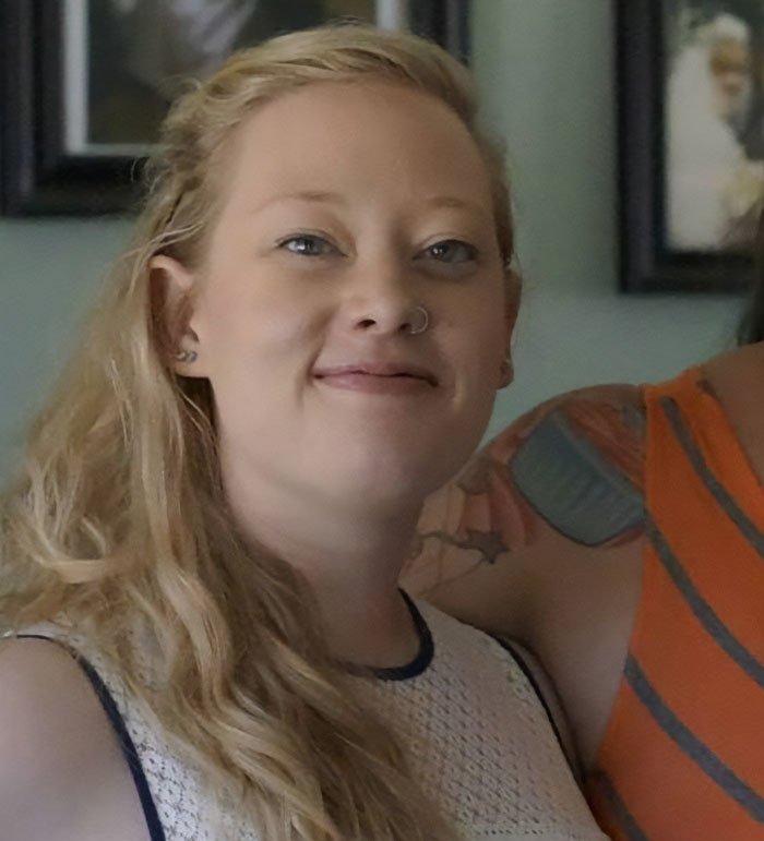 Young woman with long blonde hair and nose ring smiling, related to autopsy released by Renee Good’s family details.