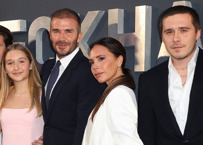 Harper Beckham standing with her parents and brother at an event, highlighting family dynamics after Brooklyn&rsquo;s attack.