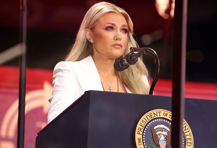 Erika Kirk speaking at a podium with presidential seal, her expression serious amid leaked clip backlash.