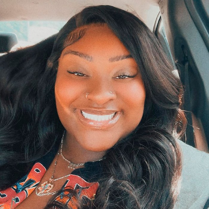 TikTok influencer smiling in car selfie after owing 1.75M for admitting inappropriate act in couple’s home.