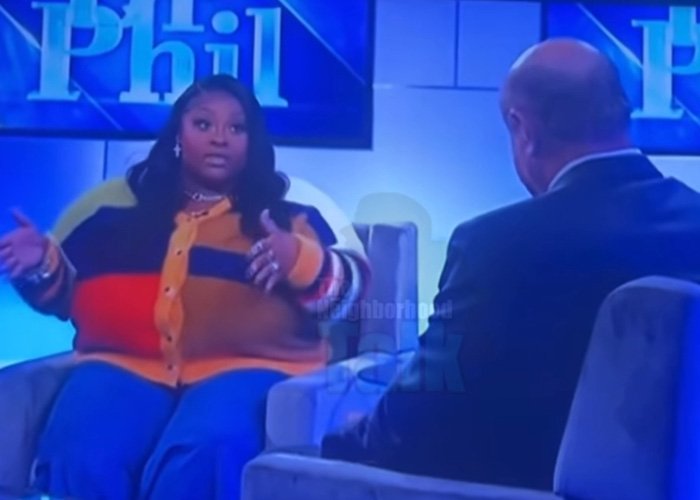 TikTok influencer in colorful sweater discussing $1.75 million debt after admitting inappropriate act on talk show set.