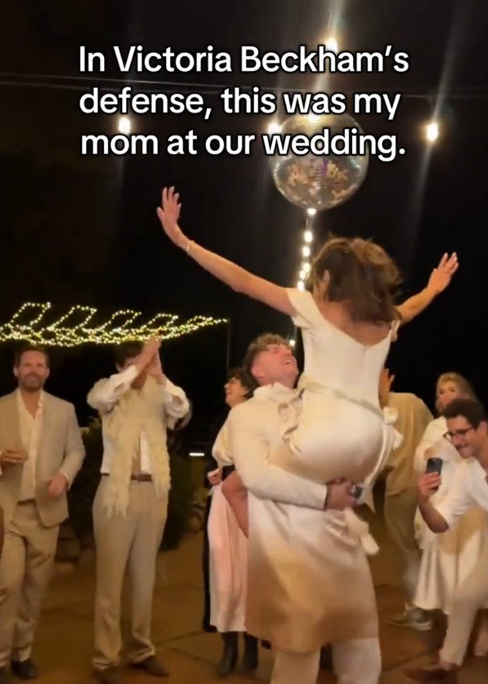 Groom’s mom dancing wildly at wedding under disco ball with guests cheering in joyful celebration amid Beckham family fallout.