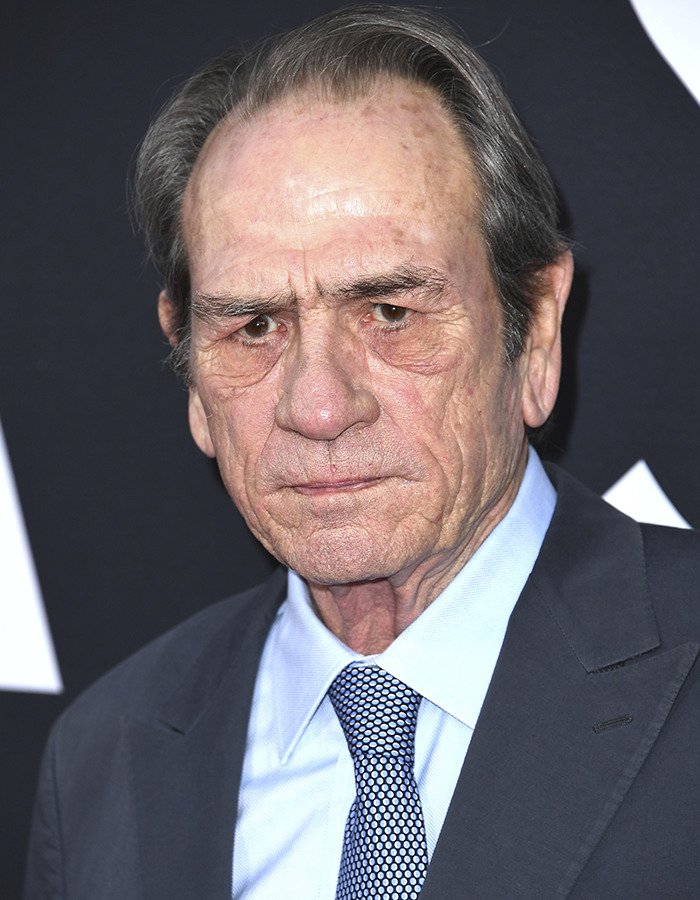 Tommy Lee Jones at a formal event, wearing a suit and tie, with court records revealing daughter Victoria’s pending plea deal.