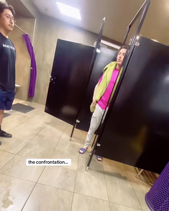 Two people in a locker room engaged in a tense confrontation related to Planet Fitness bathroom and locker room policies.