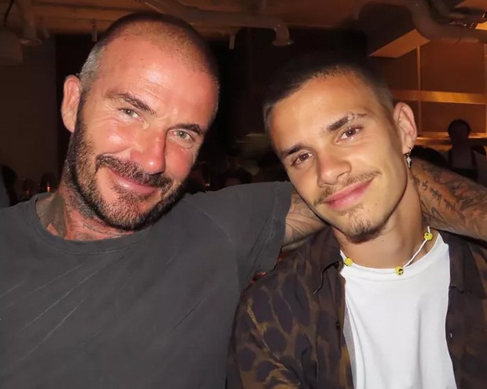 David Beckham smiling and posing with his son amid ongoing family rift and public teasing during worst crisis.