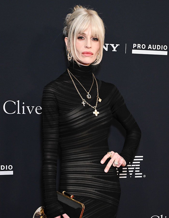 A woman in a black sheer dress at a gala, showcasing drastic weight loss sparking concern months after Ozzy's passing.