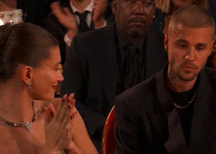 Justin Bieber showing tense body language during a moment analyzed by a body language expert on stage.
