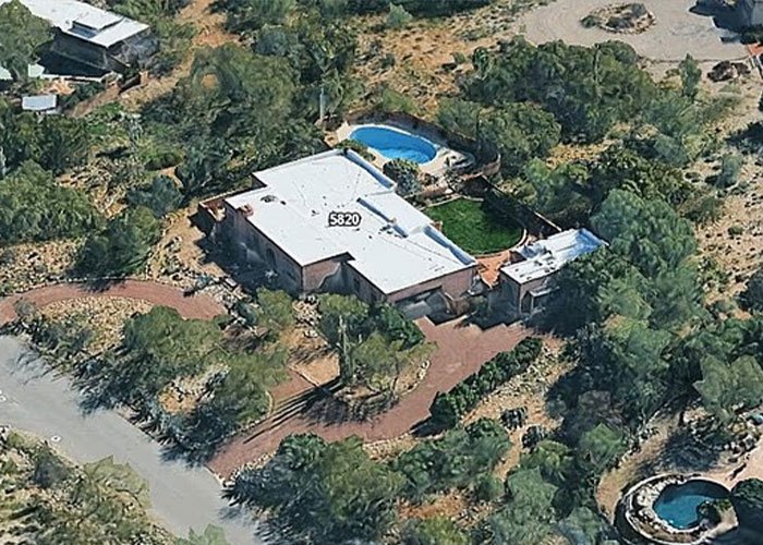 Aerial view of a secluded Arizona home surrounded by trees, relevant to police theory in Savannah Guthrie's mom case.