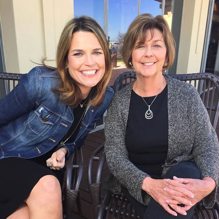 Two women sitting outdoors smiling, related to police new theory after Savannah Guthrie's mom vanished in Arizona home.