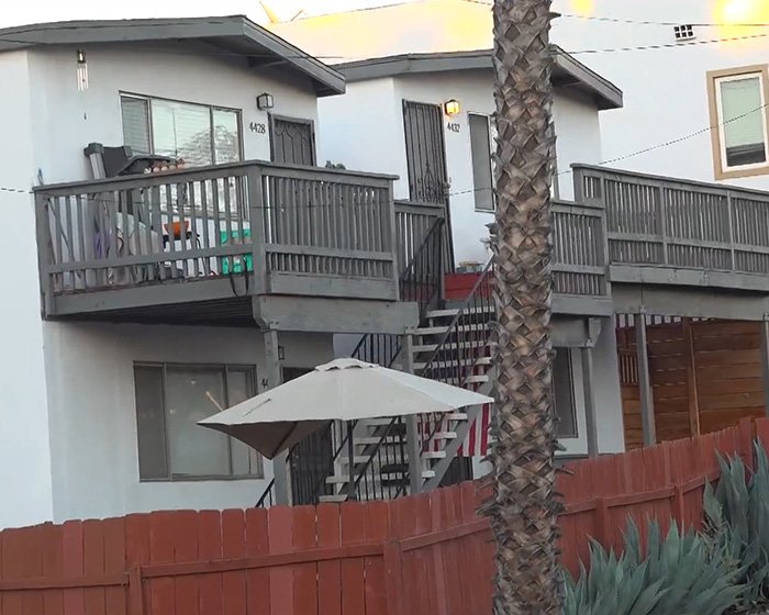 Exterior view of a residential building with balconies and stairs, related to horrifying exchange between young parents.