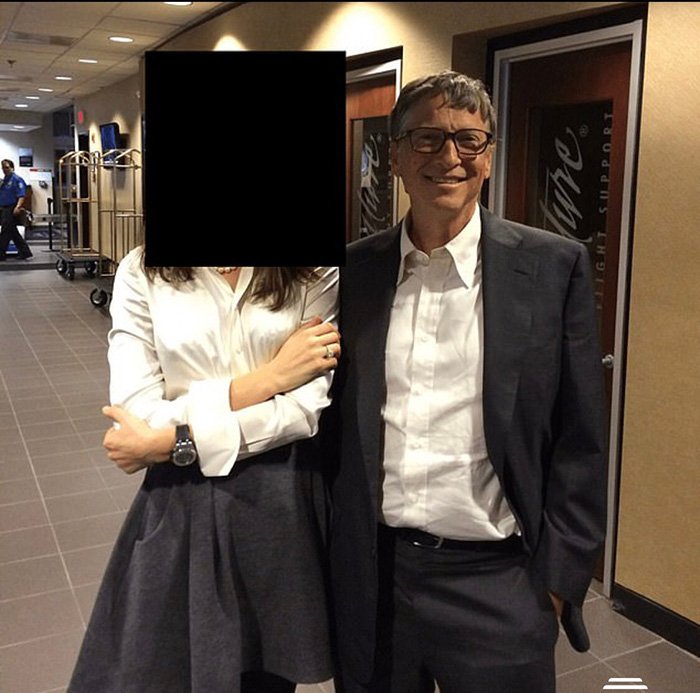 Melinda Gates and Bill Gates standing indoors, with Melinda's face obscured, related to Epstein files STD allegations topic.