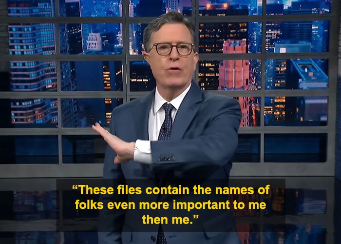 Stephen Colbert in a suit and glasses delivering a viral response on his appearance in Epstein files on a nighttime talk show set.