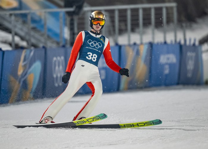 Olympic ski jumper competing on snow, illustrating controversy around injecting hyaluronic acid into the body.