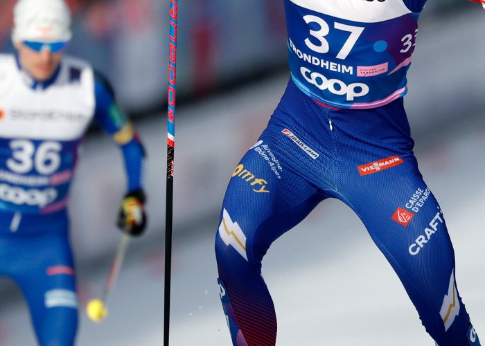 Male athlete competing in winter sports wearing blue spandex, illustrating athletic performance amid hyaluronic acid injection discussion.