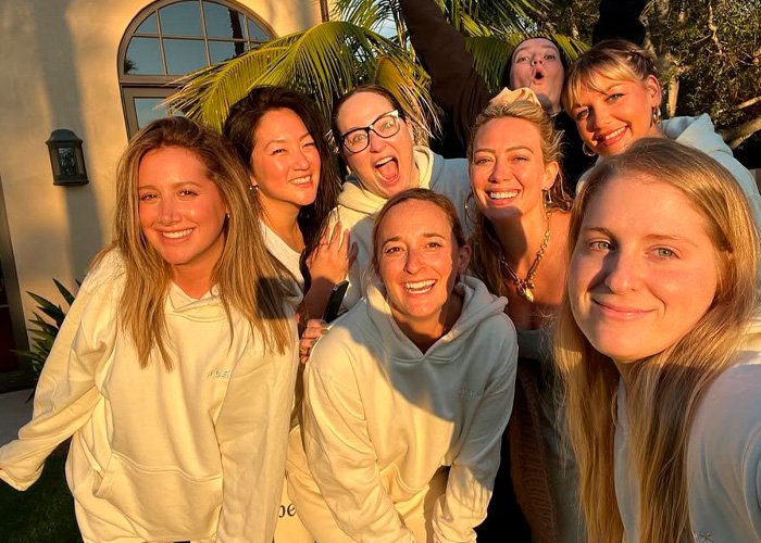 Group of women smiling outdoors in natural light, unrelated to Toxic Mom drama or Kaley Cuoco’s attack on Ashley Tisdale