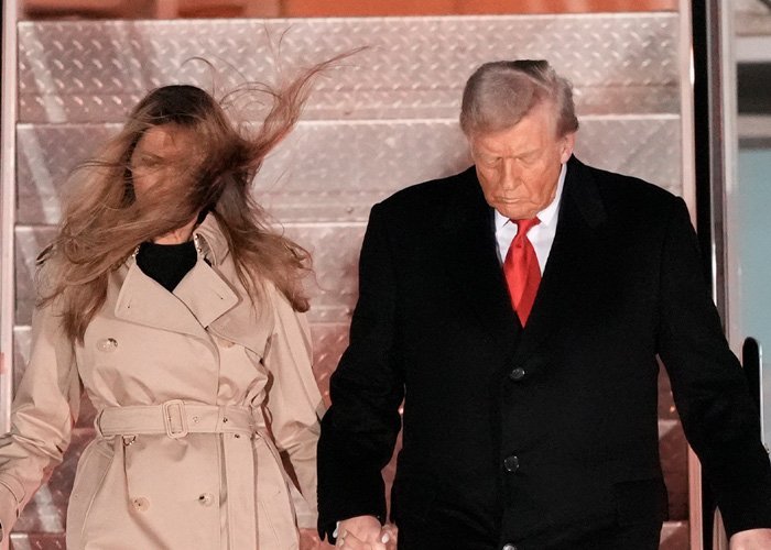 Melania Trump’s perfectly polished appearance disrupted by strong wind revealing hidden details as she walks with Donald Trump.