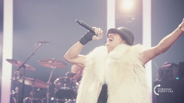 Kid Rock performing at Turning Point USA alternative Super Bowl show, sparking backlash and online controversy.