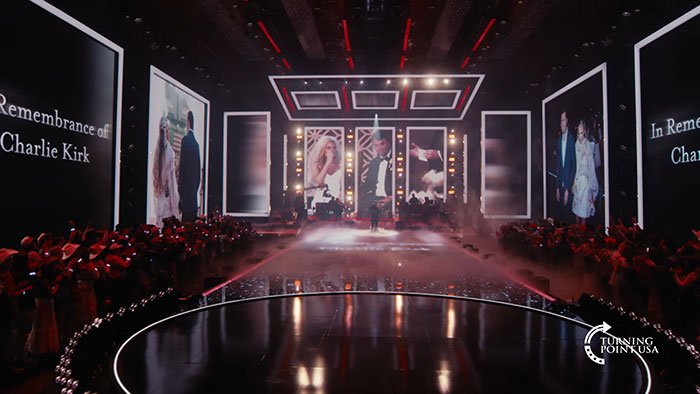 Kid Rock performing at Turning Point USA alternative Super Bowl show with a large audience and stage visuals.