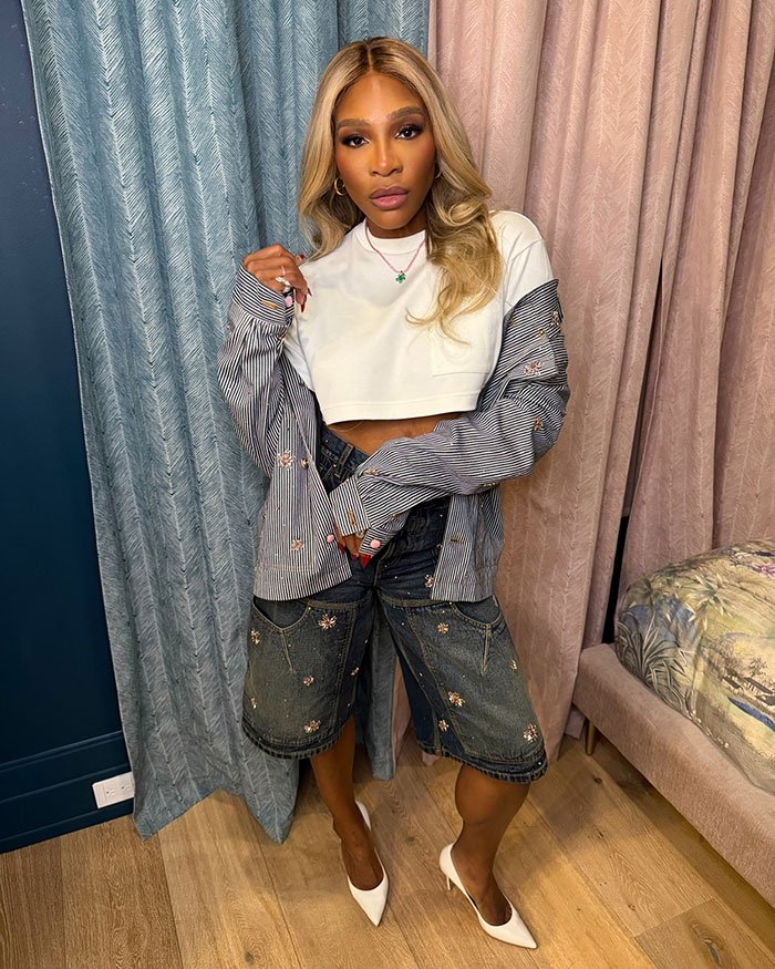 Serena Williams posing indoors in casual outfit amid controversy over Super Bowl ad and weight loss transformation.