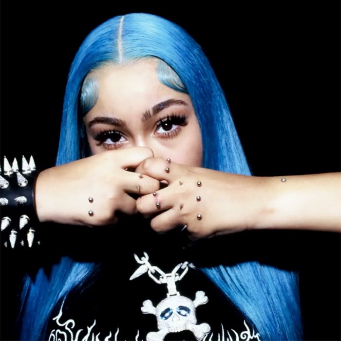 Person with blue hair showing multiple hand piercings, highlighting recent North West piercing developments and related fan reactions.