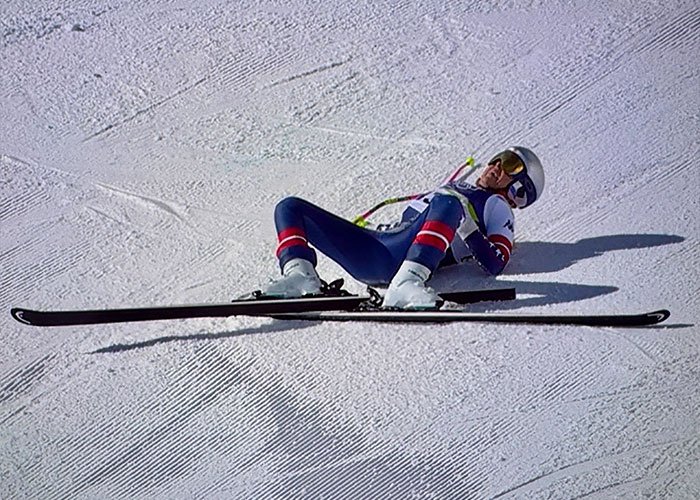 Skier lying on snow after a Winter Olympics crash, illustrating terrifying details behind Lindsey Vonn's ICU stay.