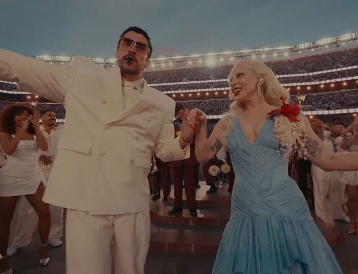Bad Bunny performing at Super Bowl, fans reacting and debating translation of explicit lyrics in a lively stadium setting.