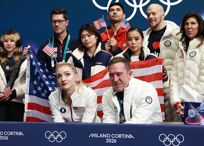 Amber Glenn with team members at Milano Cortina 2026 event, showing support amid backlash and threats over beliefs