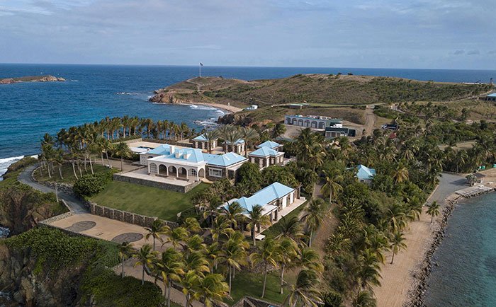 Aerial view of Epstein Island estate surrounded by ocean and palm trees, linked to sulfuric acid purchase records.