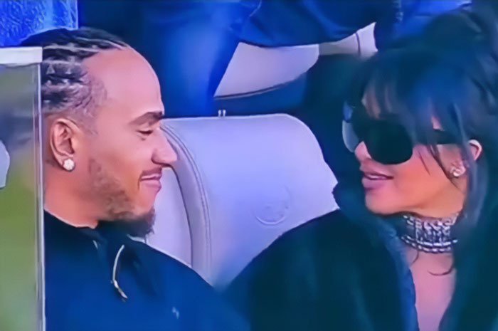 Lewis Hamilton and Kim Kardashian seated together, showing tightly controlled body language during public event.
