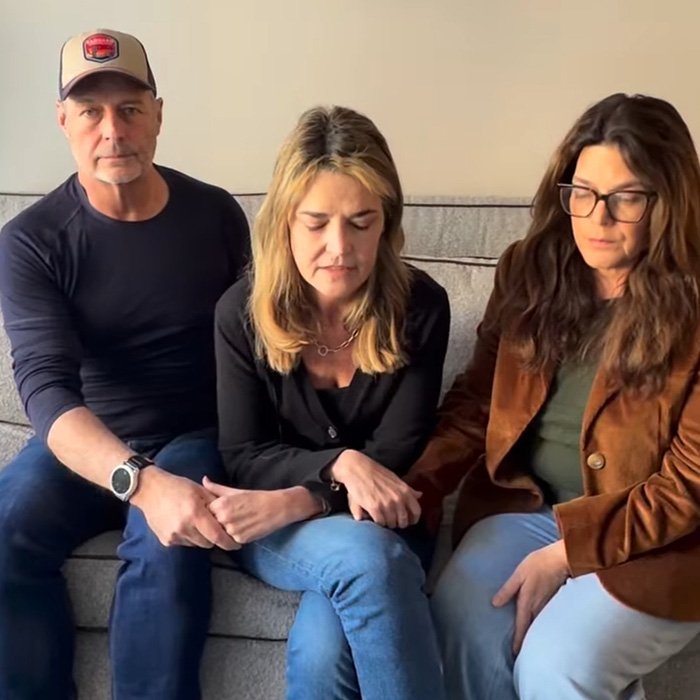 Three people seated on a couch holding hands with serious expressions, related to ransom note bitcoin demand.