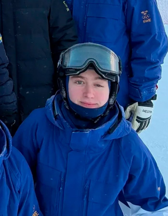 Trans Olympian in blue ski gear and goggles amid a winter setting highlighting misgendering incident controversy.