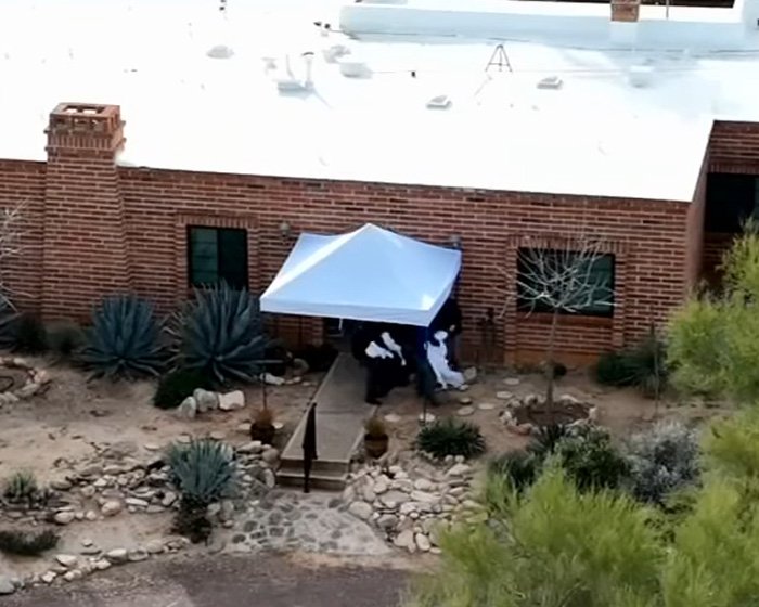 Forensics team setting up white tent at Nancy Guthrie's home amid investigation days after kidnapping incident.