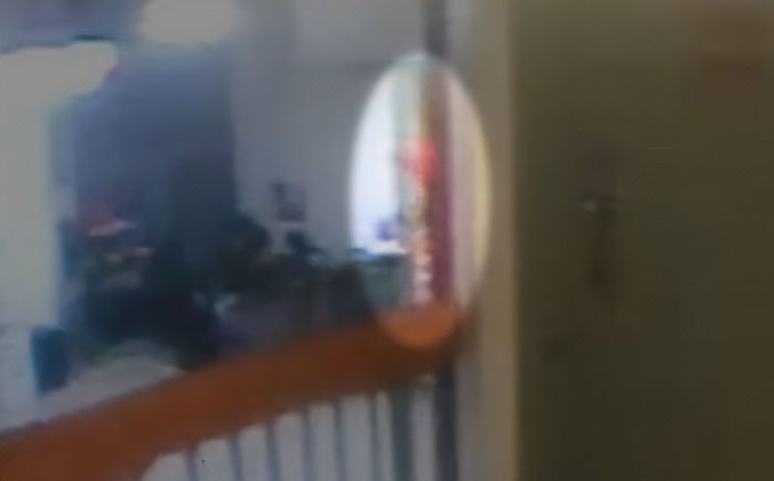 Doctor pointing at a blurry reflection during Jeffrey Epstein's post mortem, discussing how the disgraced financier passed.