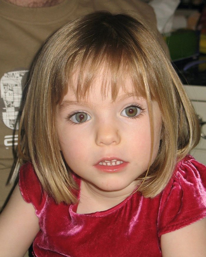Young girl with short blonde hair and green eyes wearing a red velvet dress related to Madeleine McCann abductor sketch debate.