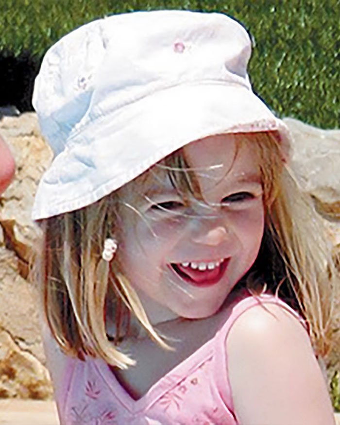 Smiling young girl wearing a white hat outdoors, related to Madeleine McCann abductor sketch debate.