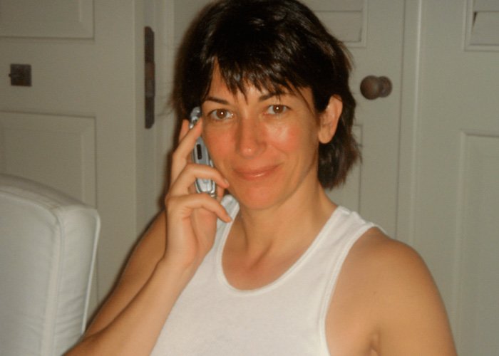 Ghislaine Maxwell in casual white tank top talking on phone, linked to internet users questioning prison appearance theory.