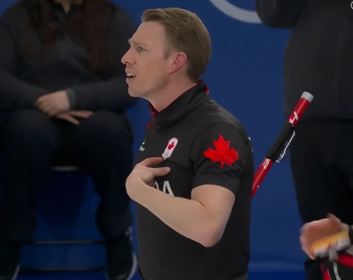 Canadian athlete reacting during a curling match amid Olympics major change after accusations of cheating by multiple countries.