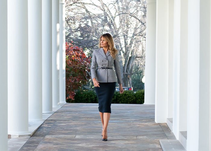 Melania Trump walking through White House colonnade, highlighting poll results on Americans' views of First Ladies.