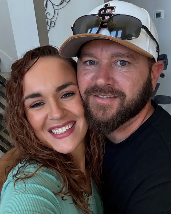 Smiling couple posing closely indoors, illustrating Utah dance mom’s mean texts and parent clash related to Vegas tragedy.